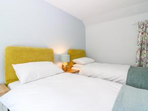two beds sitting next to each other in a room at 2 Tougal in Mallaig