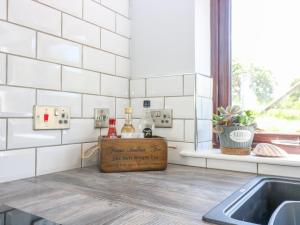 a kitchen with a counter with two bottles of alcohol at 2 Tougal in Mallaig