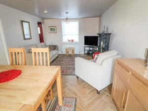 a living room with a couch and a table at Cranny Corner in Ballymena