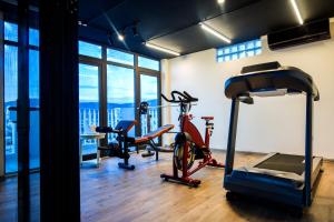 a gym with a treadmill and two exercise bikes at IBIZA Danang Riverfront Hotel in Danang