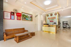 a living room with a couch and a table at Marine Hotel & Apartment in Vung Tau