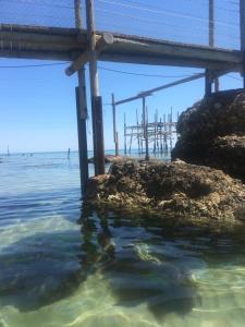 a dock in the water next to the ocean at B&B La Perla in Vasto