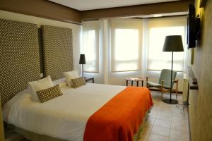 Ένα ή περισσότερα κρεβάτια σε δωμάτιο στο Hotel ACA El Calafate