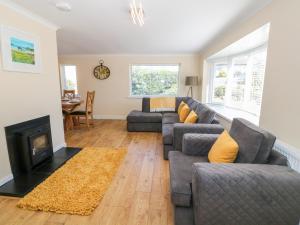 a living room with a couch and a fireplace at Croeso in Cemaes Bay