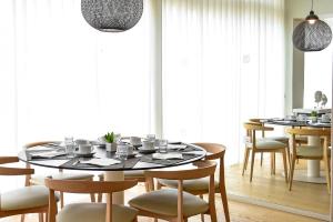 a dining room with a table and chairs at Aqualuz Lagos by The Editory in Lagos
