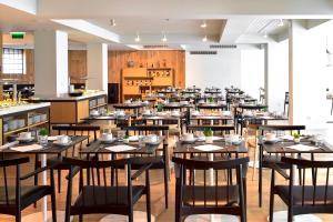 a large dining room with tables and chairs at Aqualuz Lagos by The Editory in Lagos
