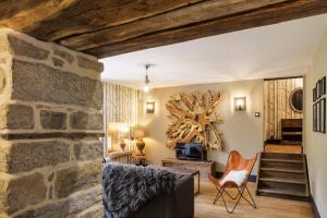 a living room with a stone wall at Côté Rivière in Nevy-sur-Seille +40 photos