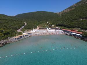 a group of people in the water at a beach at Trsteno Beach Apartments in Budva