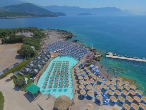 an aerial view of a resort with a pool and umbrellas at Trsteno Beach Apartments in Budva
