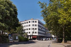 a white building on the side of a street at Hotel San Lázaro in Santiago de Compostela