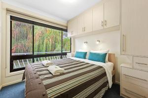 A bed or beds in a room at Renmark River Villas and Boats & Bedzzz