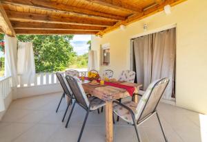 a dining room with a wooden table and chairs at Holiday Home Tina in Cavtat