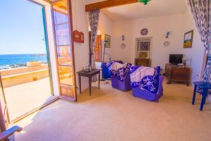 a living room with a view of the ocean at Authentic fisherman's house on the seafront in Cala Ratjada