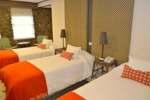 Postel nebo postele na pokoji v ubytování Hotel ACA El Calafate