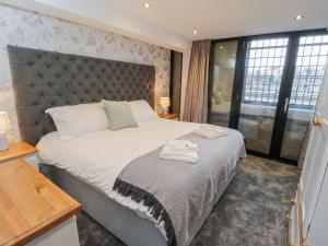 a bedroom with a large bed with a large window at Sir Nigel Gresley Engine Shed in Whitby