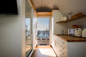 a kitchen with a view of the ocean from a boat at Samphire Ark 900 in Emsworth