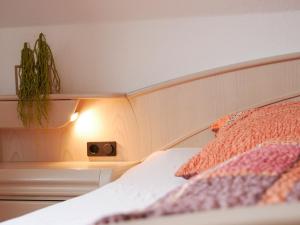 a bedroom with a bed with a plant on the wall at Haus Philipp in Bad Urach
