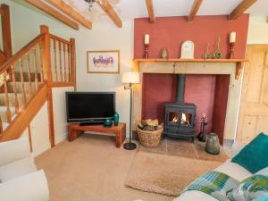 a living room with a fireplace and a tv at Fenwick Retreat at Fenwick Lodge in Newcastle upon Tyne