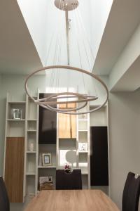 a dining room with a circular light fixture at Casa Bella WHC in Cluj-Napoca