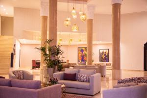 a lobby with couches and chairs in a building at Marrakech Ryads Parc All inclusive in Marrakesh