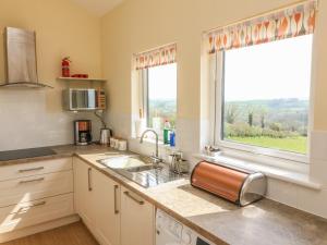 a kitchen with a sink and a window at Valley View in Tiverton