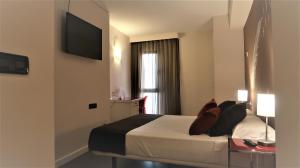 Säng eller sängar i ett rum på Hotel Teruel Plaza