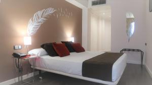 Säng eller sängar i ett rum på Hotel Teruel Plaza
