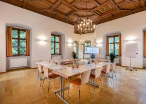 a large room with a large table and chairs at JUFA Hotel Schloss Röthelstein in Admont