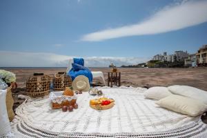 a picnic table with food on the beach at Aparthotel Barracuda in Ponta Delgada