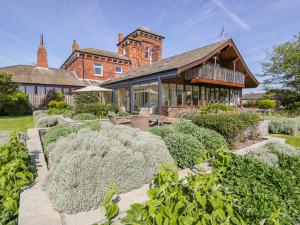 an exterior view of a house with a garden at Villa Marina in Barrow in Furness