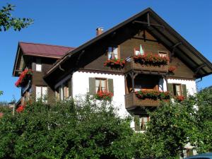 a house with flower boxes on the side of it at Alpstein Appartements in Bad Hindelang
