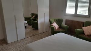 a waiting room with green chairs and a mirror at Gallipoli, climatizzato, a 100 metri dalla spiaggia in Lido Conchiglie