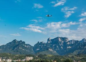 a plane flying in front of a mountain at Dao Bian Inn in Zhangjiajie