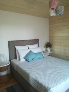 a bedroom with a large bed with blue pillows at CAMPO DE SOBARBO - Guest House rural in Penafiel