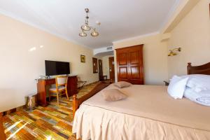 a bedroom with a bed and a desk and a television at Vila Preciosa in Alba Iulia +77 photos