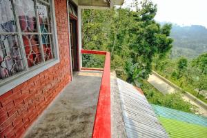a building with a red line next to a window at Vamoose Shraddha in Aritar