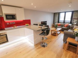 a kitchen and living room with a table and a couch at Olton Hall Engine Shed in Whitby
