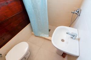a bathroom with a toilet and a sink at Apartments Obala in Podgorica
