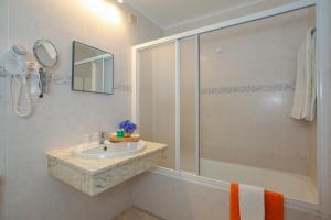 a bathroom with a sink and a shower at Aparthotel Barracuda in Ponta Delgada +34 photos
