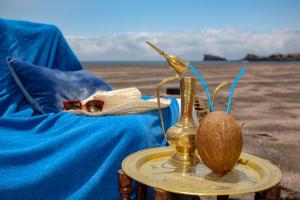 a close up of a bottle and a coconut on a table at Aparthotel Barracuda in Ponta Delgada
