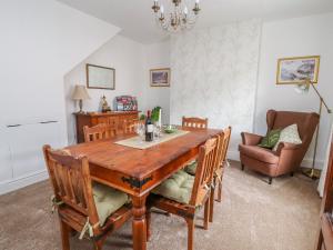 a dining room with a wooden table and chairs at Llewelyn House in Llandudno