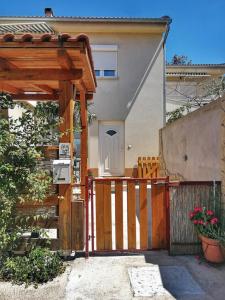 a wooden gate to a house with a fence at Jasmina in Senj