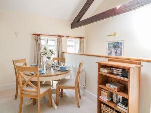 a dining room with a table and chairs at The Tallet in Dartmouth