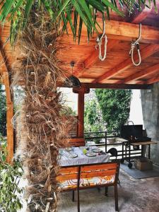 a table under a wooden pergola with a tableablish at Jasmina in Senj
