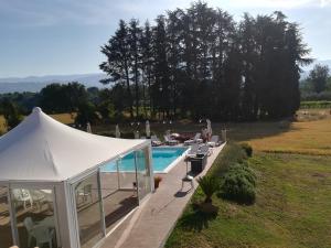 a white tent next to a swimming pool at Grotta Biscia in Genazzano