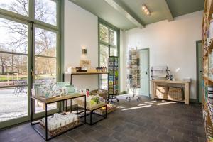 a store with a lot of windows in a room at Gasterij Leyduin in Vogelenzang