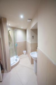 a bathroom with a shower and a toilet and a sink at Palmerston Suites in Edinburgh