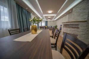 a conference room with a long table and chairs at Al Hayat Apartments in Vogošća