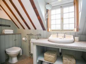 a bathroom with a sink and a toilet at Murton Cottage in Burford +26 photos