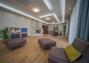 a living room with two couches and a fireplace at Al Hayat Apartments in Vogošća